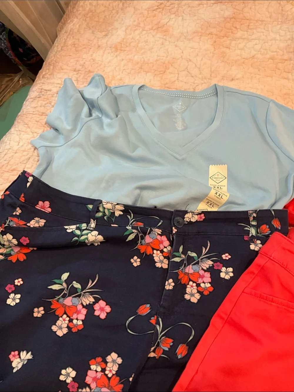 Coral Red V-Neck Top with Floral Navy Pants and Light Blue Tee